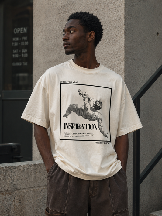 Man wearing a white t-shirt with a graphic design standing against a building.Stylist streetwear tee, comfy formal tee, fashion tee, graphic tee