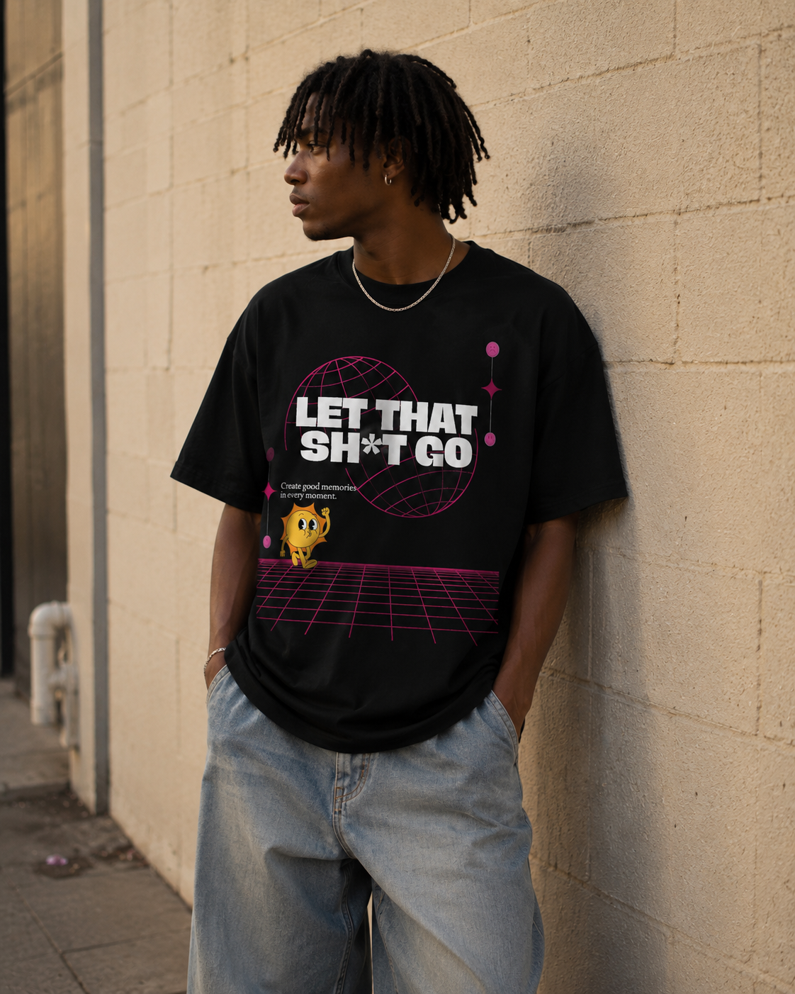 Person wearing a black t-shirt with graphic design and text, standing against a beige wall. Stylist streetwear tee, comfy formal tee, fashion tee, graphic tee