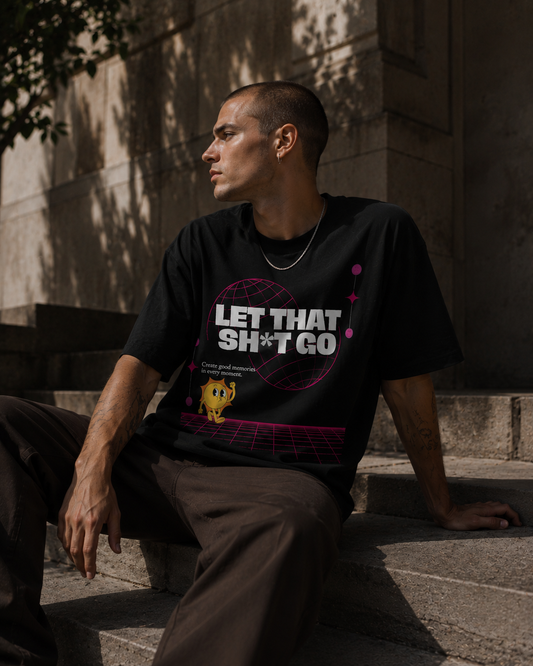 Person wearing a black t-shirt with text sitting on steps outdoors. Stylist streetwear tee, comfy formal tee, fashion tee, graphic tee