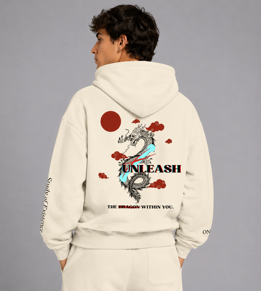 Person wearing a beige hoodie with a dragon design and text on the back, on a gray background. Stylist streetwear hoodie, comfy formal hoodie, fashion hoodie, graphic hoodie, no front pocket hoodie, large hooded hoodie, large hood hoodie, oversized hoodie