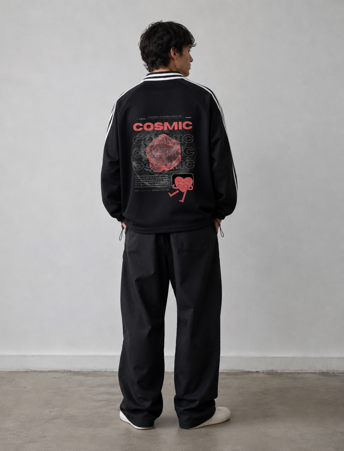 Person wearing a black tracksuit with 'Cosmic' design on the back against a plain background. Stylist streetwear collar Sweatshirt, comfy formal collar Sweatshirt, fashion collar Sweatshirt, graphic collar Sweatshirt
