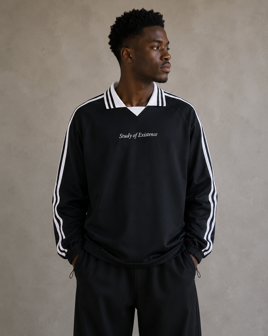Man wearing a black tracksuit with white stripes and 'Study of Existence' text on a beige background. Man wearing Black sweatshirt with white stripes and 'Study of Existence' text on a white background. Stylist streetwear collar Sweatshirt, comfy formal collar Sweatshirt, fashion collar Sweatshirt, graphic collar Sweatshirt.