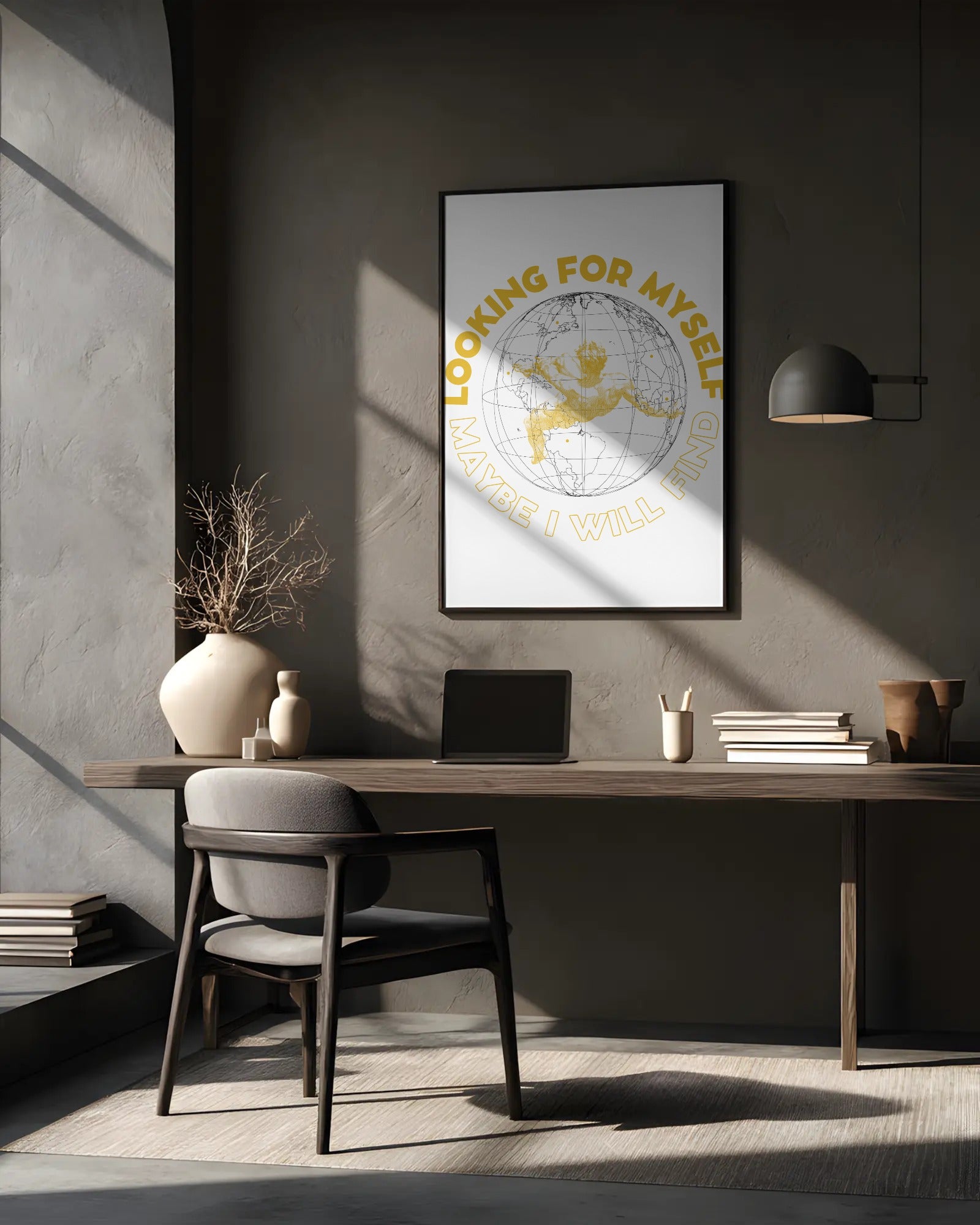 Modern office setup with a desk, chair, and framed artwork on a gray wall.