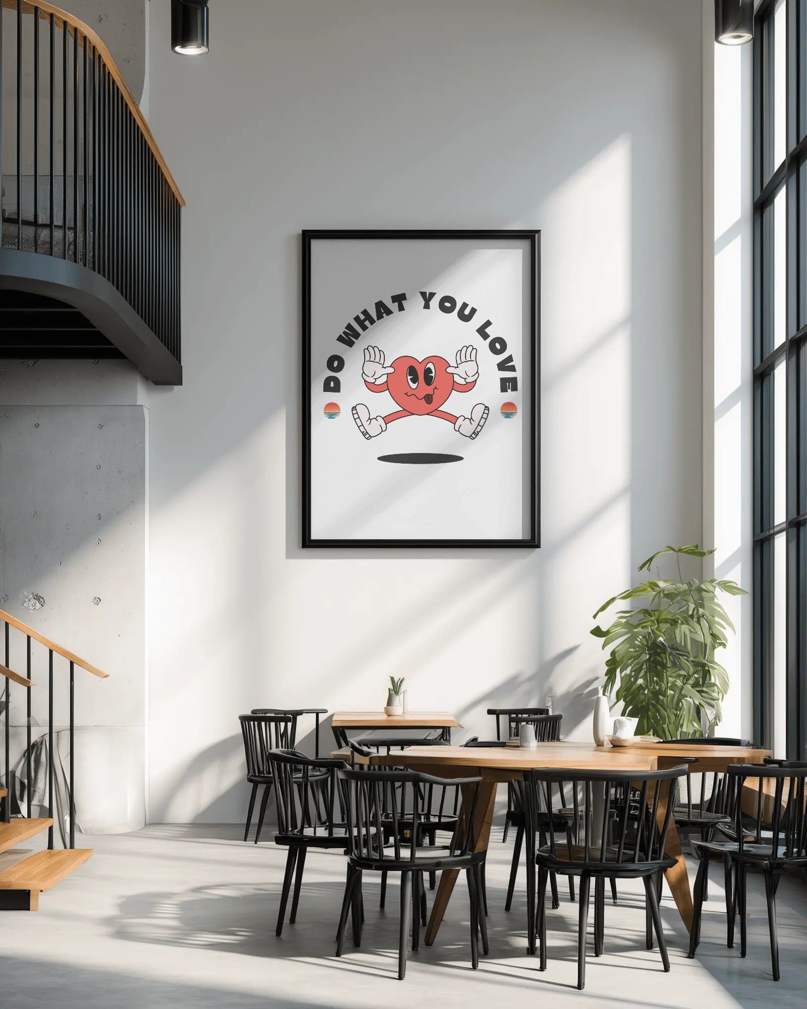 Modern interior with a framed motivational poster on the wall, wooden tables, and black chairs.