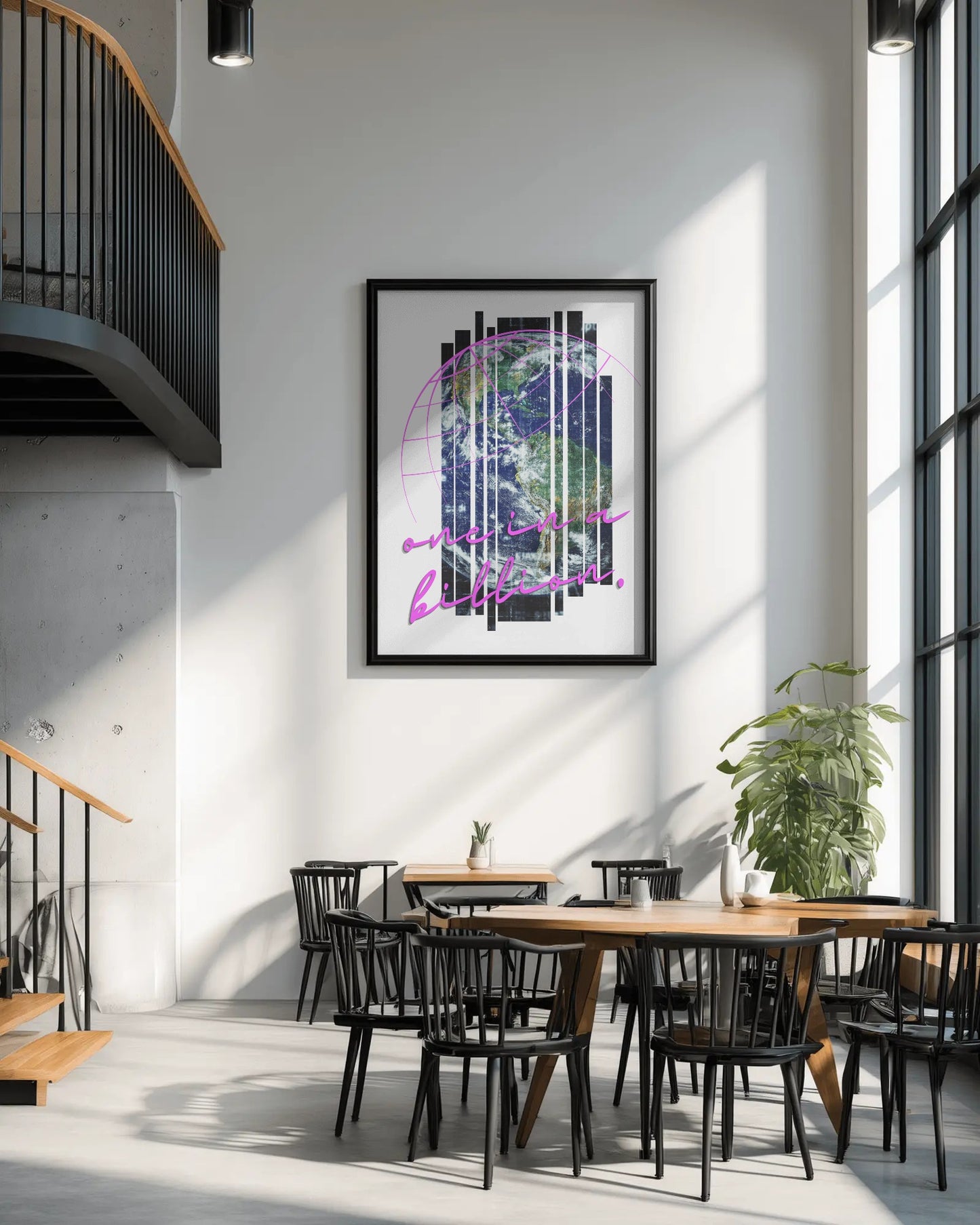 Modern interior with a framed abstract artwork on the wall, wooden tables, and black chairs.
