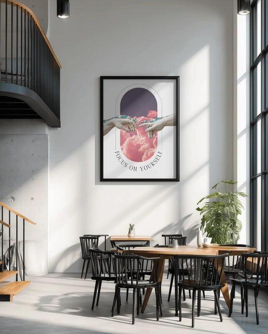 Modern interior with a framed artwork on the wall, wooden tables, and black chairs.