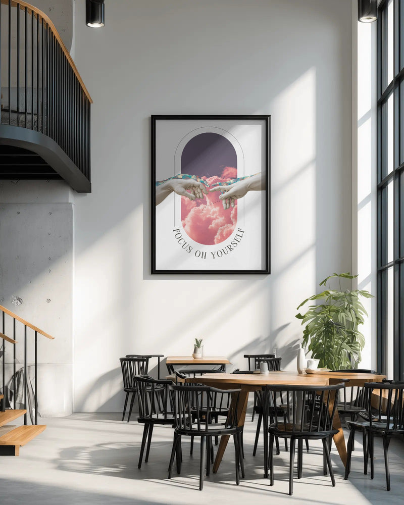 Modern interior with a framed artwork on the wall, wooden tables, and black chairs.