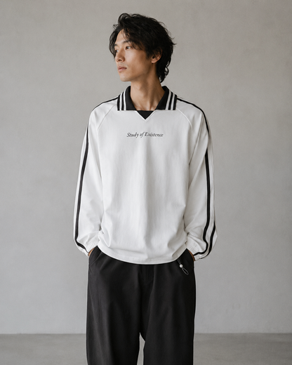 Person wearing a white sweatshirt with black stripes and text, standing against a plain background Stylist streetwear collar Sweatshirt, comfy formal collar Sweatshirt, fashion collar Sweatshirt, graphic collar Sweatshirt