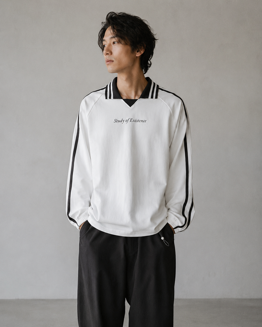 Person wearing a white sweatshirt with black stripes and text, standing against a plain background Stylist streetwear collar Sweatshirt, comfy formal collar Sweatshirt, fashion collar Sweatshirt, graphic collar Sweatshirt
