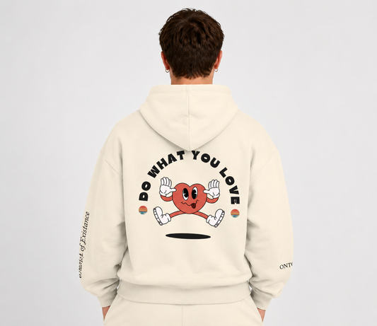 Person wearing a beige hoodie with a graphic design on the back against a light gray background. Stylist streetwear hoodie, comfy formal hoodie, fashion hoodie, graphic hoodie, no front pocket hoodie, large hooded hoodie, large hood hoodie, oversized hoodie