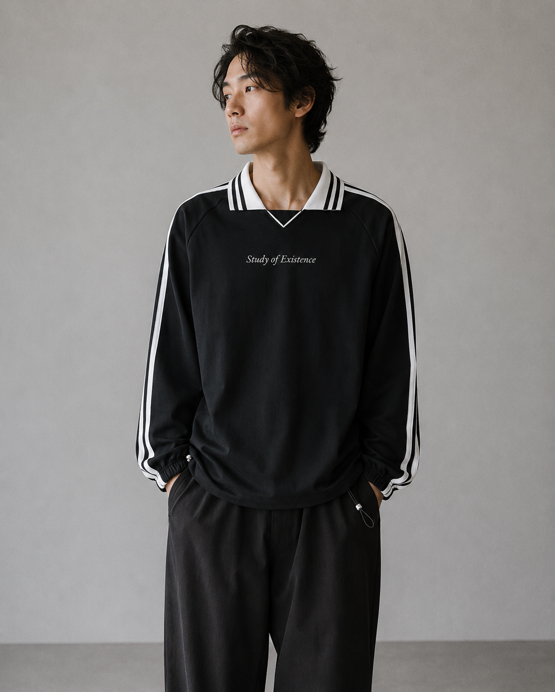 Man wearing a black tracksuit with white stripes and text on a plain background Stylist streetwear collar Sweatshirt, comfy formal collar Sweatshirt, fashion collar Sweatshirt, graphic collar Sweatshirt