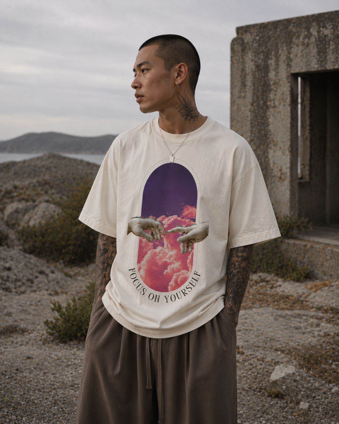 Man wearing a t-shirt with a graphic design in a desert setting. Stylist streetwear tee, comfy formal tee, fashion tee, graphic tee