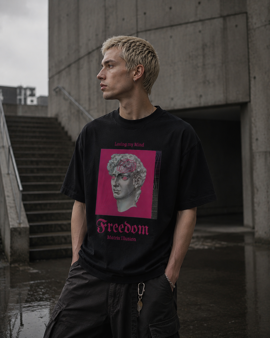 Person wearing a black t-shirt with a graphic design in an urban setting. Stylist streetwear tee, comfy formal tee, fashion tee, graphic tee