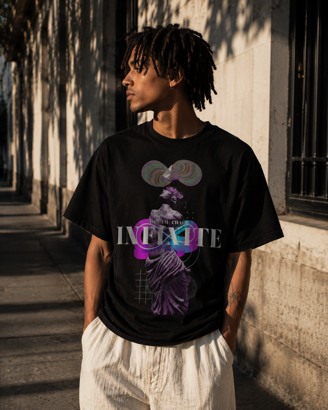 Person wearing a black t-shirt with a colorful graphic design outdoors. Stylist streetwear tee, comfy formal tee, fashion tee, graphic tee