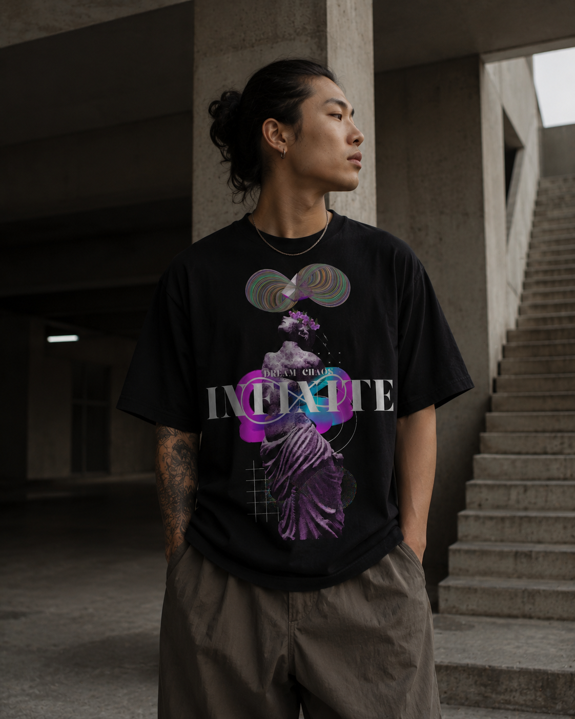Person wearing a black t-shirt with a colorful graphic design in an urban setting. Stylist streetwear tee, comfy formal tee, fashion tee, graphic tee