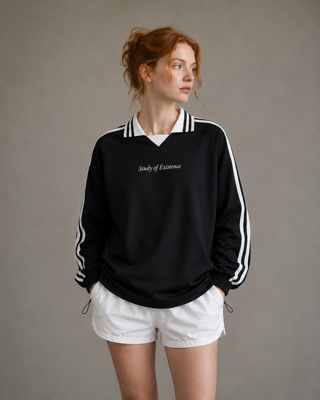 Person wearing a black sweatshirt with white text and white shorts on a neutral background. Stylist streetwear collar Sweatshirt, comfy formal collar Sweatshirt, fashion collar Sweatshirt, graphic collar Sweatshirt