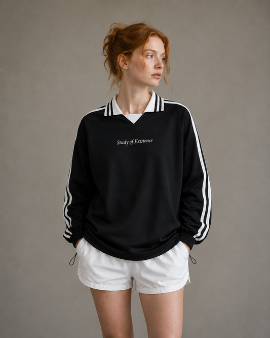 Person wearing a black sweatshirt with white text and white shorts on a neutral background. Stylist streetwear collar Sweatshirt, comfy formal collar Sweatshirt, fashion collar Sweatshirt, graphic collar Sweatshirt