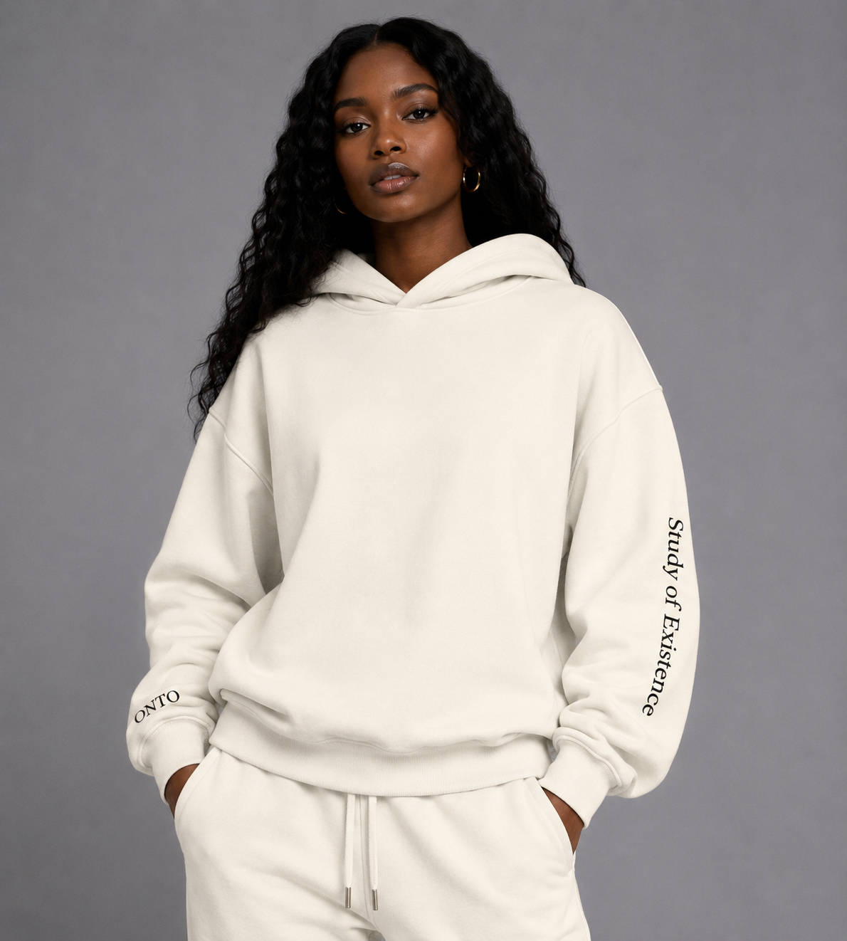 Person wearing a white hoodie with text on sleeves against a gray background.Stylist streetwear hoodie, comfy formal hoodie, fashion hoodie, graphic hoodie, no front pocket hoodie, large hooded hoodie, large hood hoodie, oversized hoodie