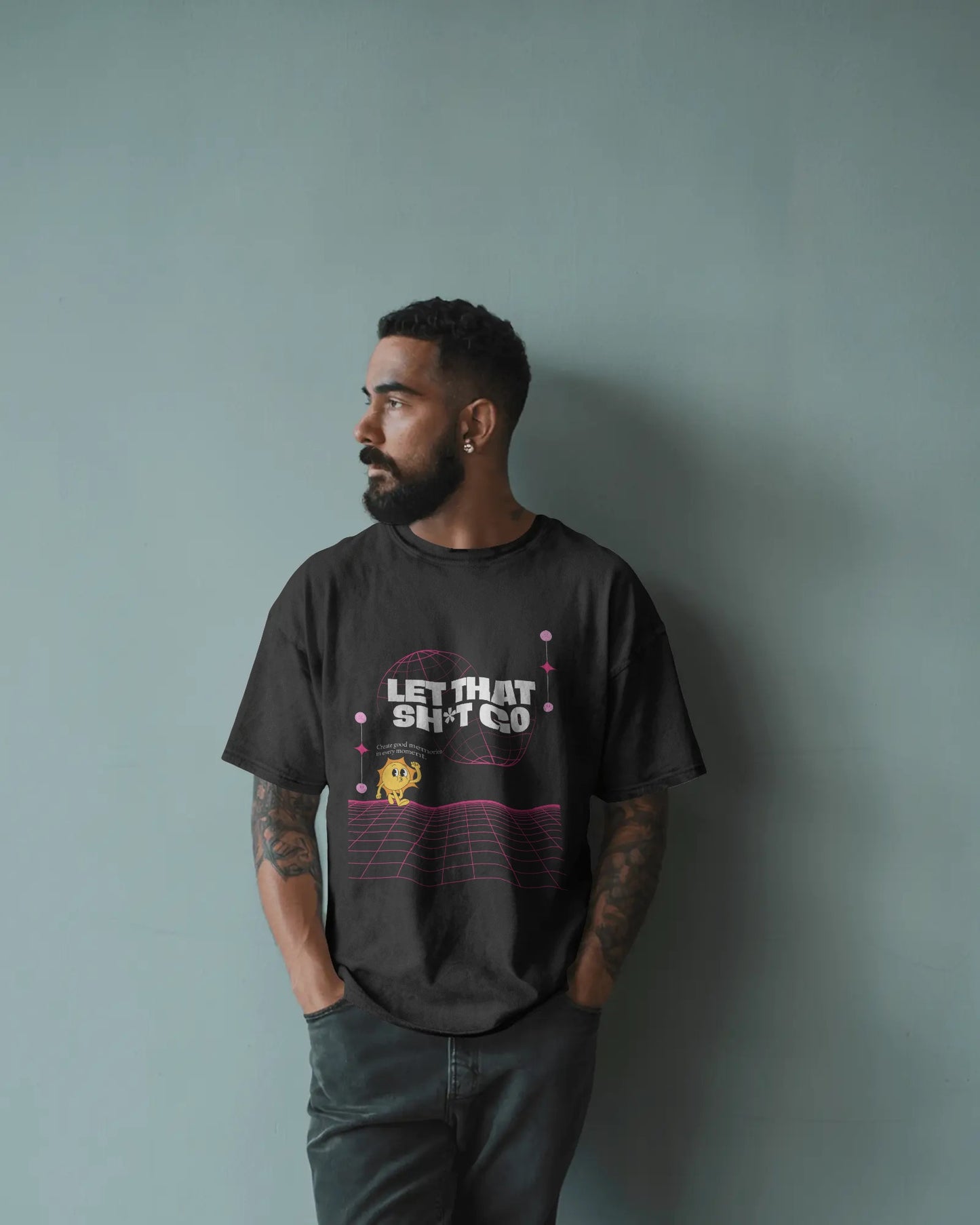 Man wearing a black t-shirt with text and graphics against a gray background