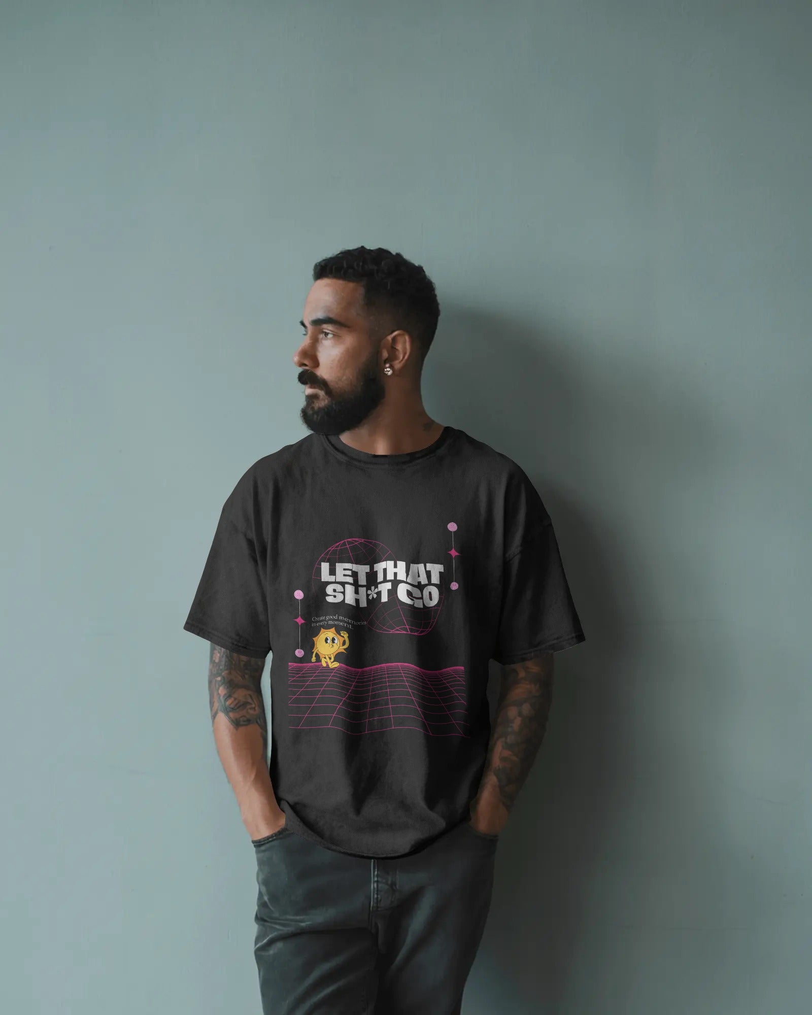 Man wearing a black t-shirt with text and graphics against a gray background