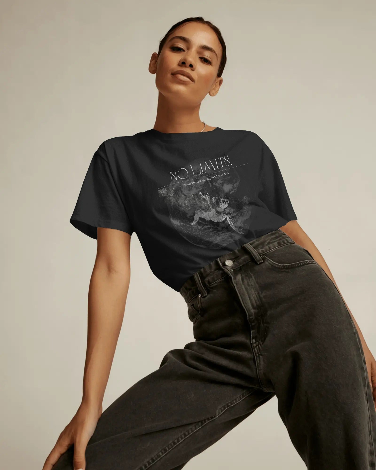 Person wearing a black t-shirt with 'No Limits' text and graphic design.