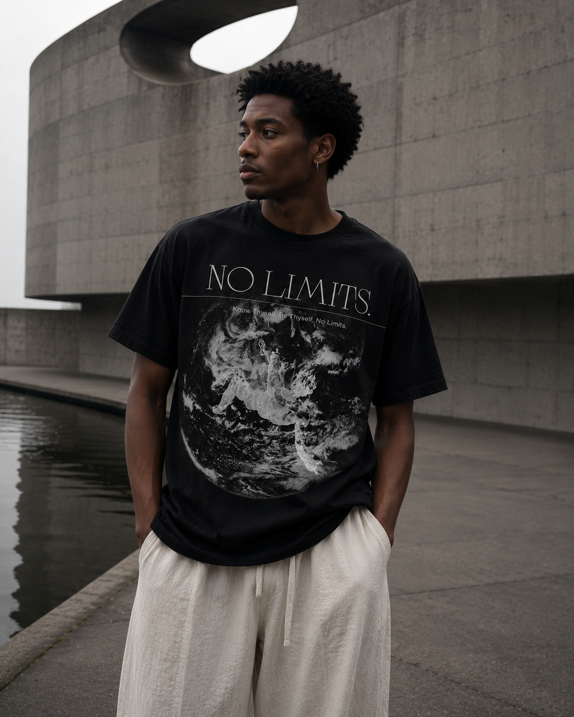 Person wearing a black t-shirt with 'No Limits' graphic design outdoors. Stylist streetwear tee, comfy formal tee, fashion tee, graphic tee