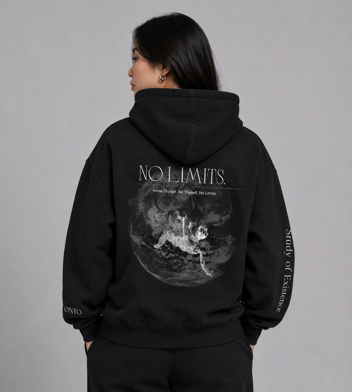 Person wearing a black hoodie with 'NO LIMITS' graphic and text on a gray background. Stylist streetwear hoodie, comfy formal hoodie, fashion hoodie, graphic hoodie, no front pocket hoodie, large hooded hoodie, large hood hoodie, oversized hoodie