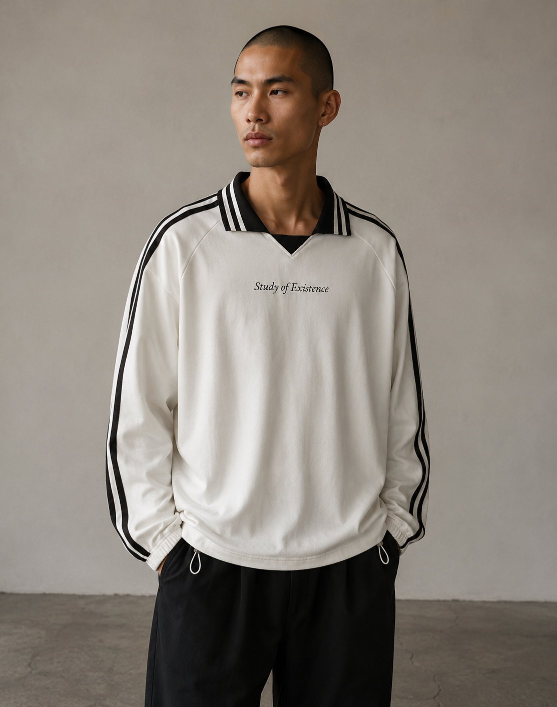 Man wearing a white sweatshirt with black stripes and text, standing against a plain background. Stylist streetwear collar Sweatshirt, comfy formal collar Sweatshirt, fashion collar Sweatshirt, graphic collar Sweatshirt