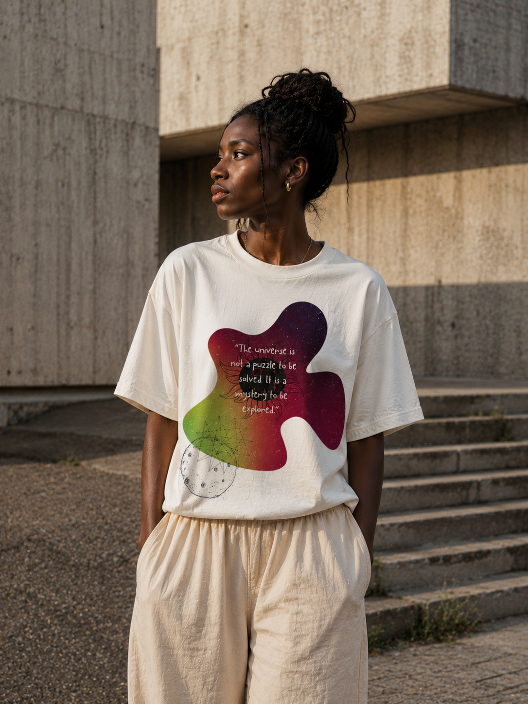 Person wearing a white t-shirt with a colorful design and text, standing outdoors. Stylist streetwear tee, comfy formal tee, fashion tee, graphic tee