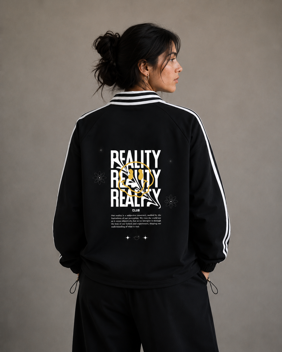 Person wearing a black tracksuit with 'REALITY' text on the back against a gray background.Stylist streetwear collar Sweatshirt, comfy formal collar Sweatshirt, fashion collar Sweatshirt, graphic collar Sweatshirt