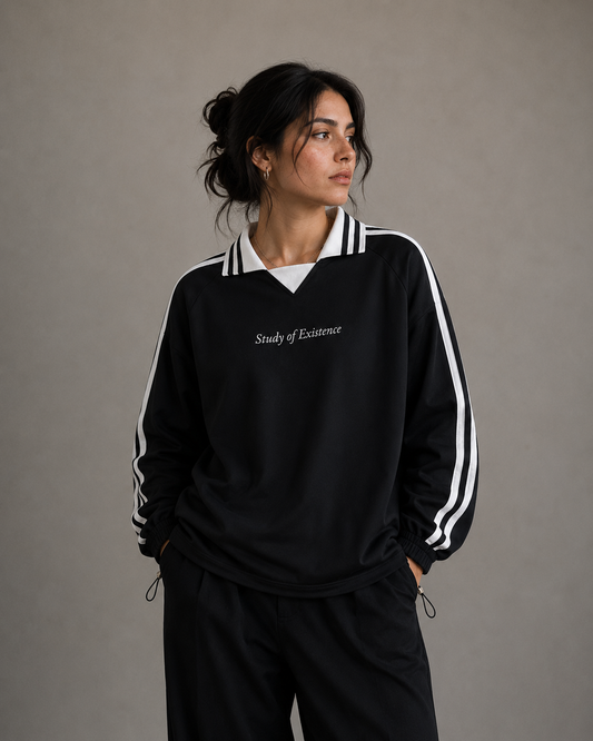 Person wearing a black tracksuit with white stripes and text on a plain background. Stylist streetwear collar Sweatshirt, comfy formal collar Sweatshirt, fashion collar Sweatshirt, graphic collar Sweatshirt