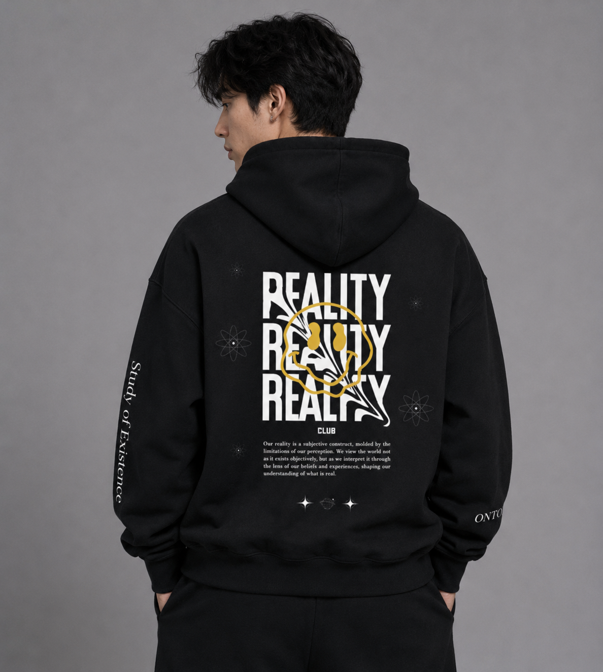 Person wearing a black hoodie with 'REality' text design on the back against a gray background. Black hoodie with text on sleeves against a white background. Stylist streetwear hoodie, comfy formal hoodie, fashion hoodie, graphic hoodie, no front pocket hoodie, large hooded hoodie, large hood hoodie, oversized hoodie