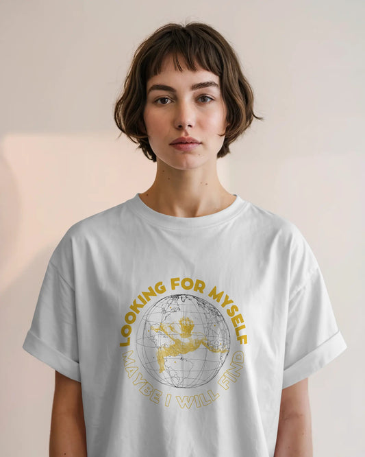 Person wearing a light gray t-shirt with a graphic design and text on a plain background