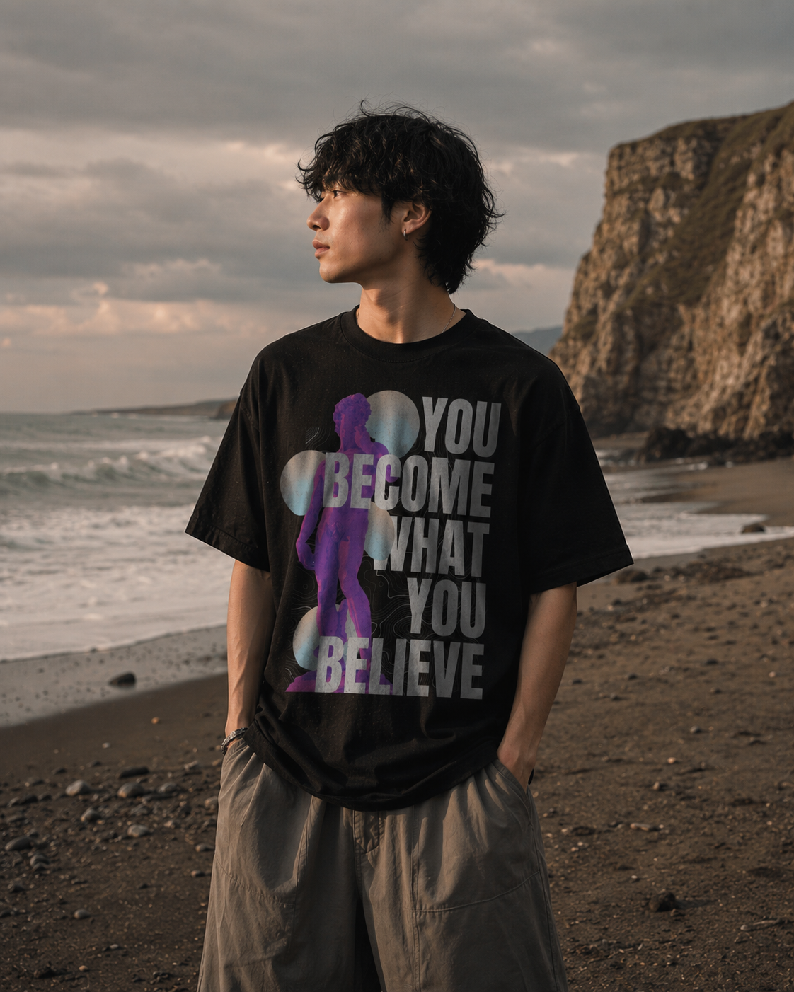 Person wearing a black t-shirt with an inspirational quote on a beach Stylist streetwear tee, comfy formal tee, fashion tee, graphic tee