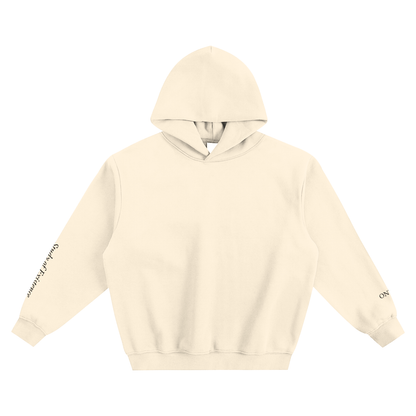 Beige hoodie with text on sleeves against a white background