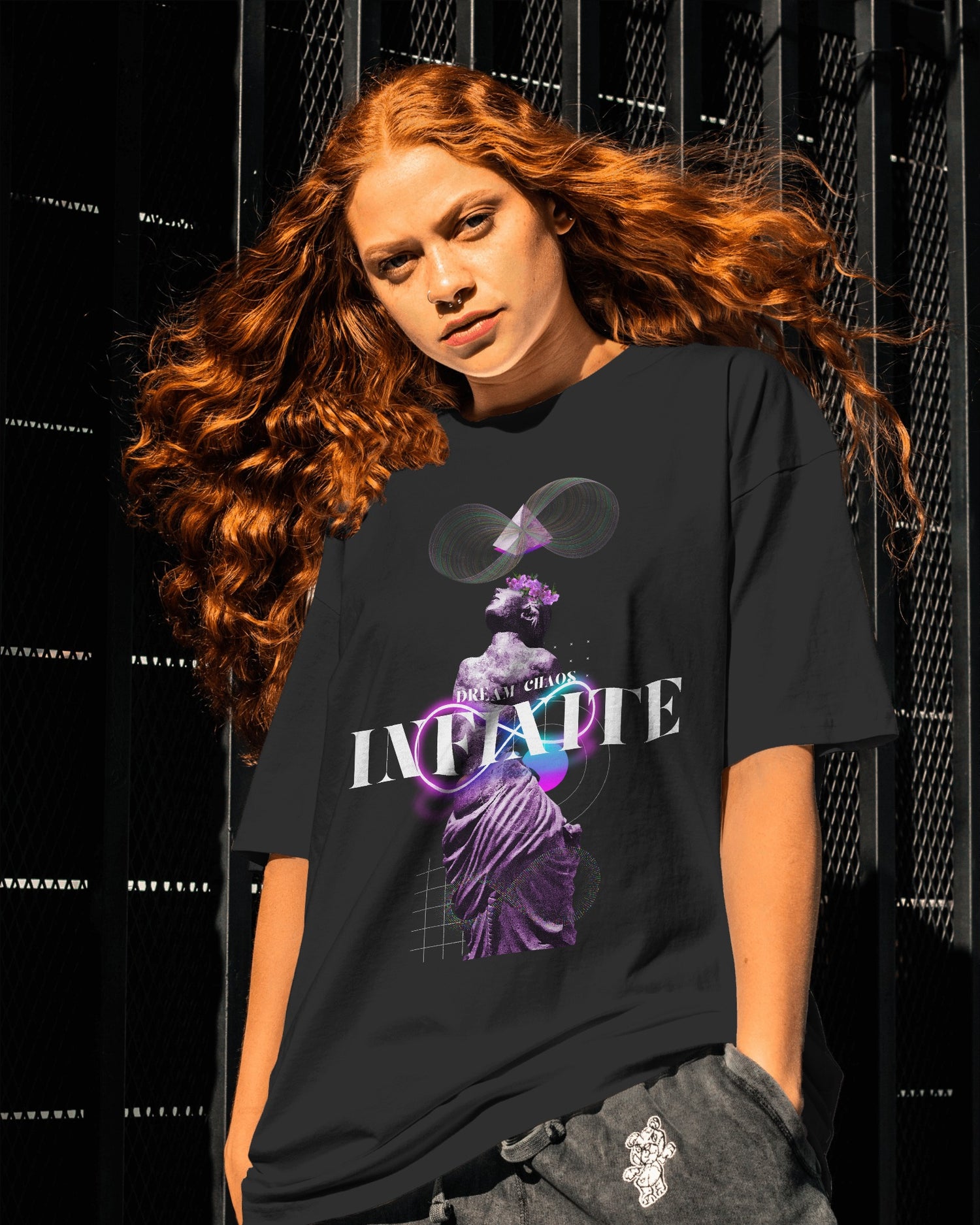 Person wearing a black t-shirt with a graphic design and text against a dark background