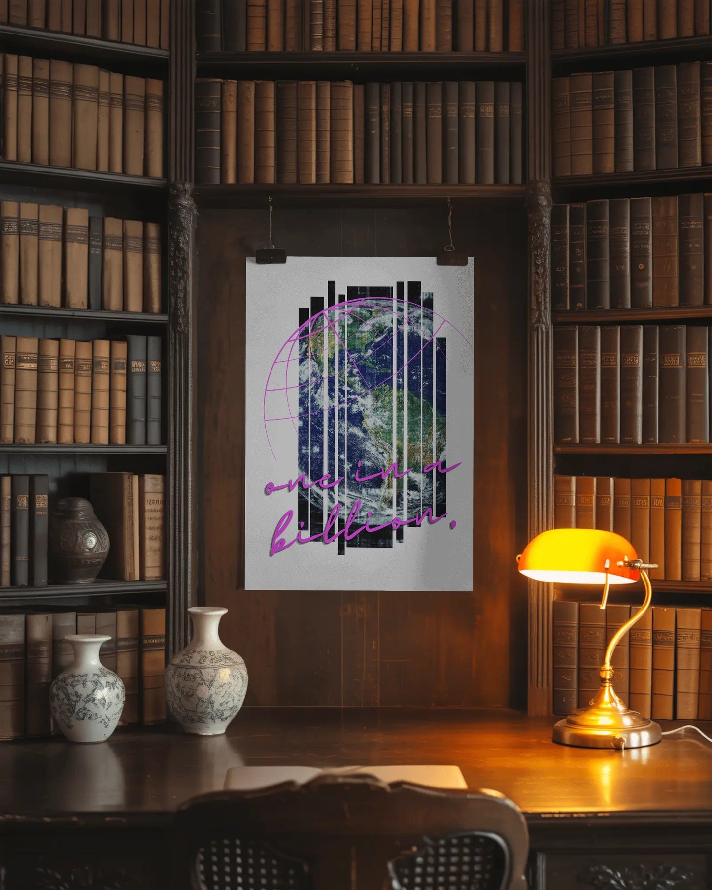 Framed artwork on a bookshelf with a lamp and decorative vases.