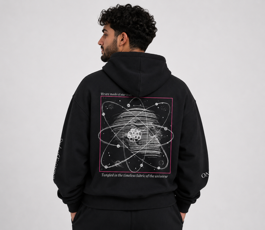 Person wearing a black hoodie with a scientific design on the back against a plain background. Stylist streetwear hoodie, comfy formal hoodie, fashion hoodie, graphic hoodie, no front pocket hoodie, large hooded hoodie, large hood hoodie, oversized hoodie