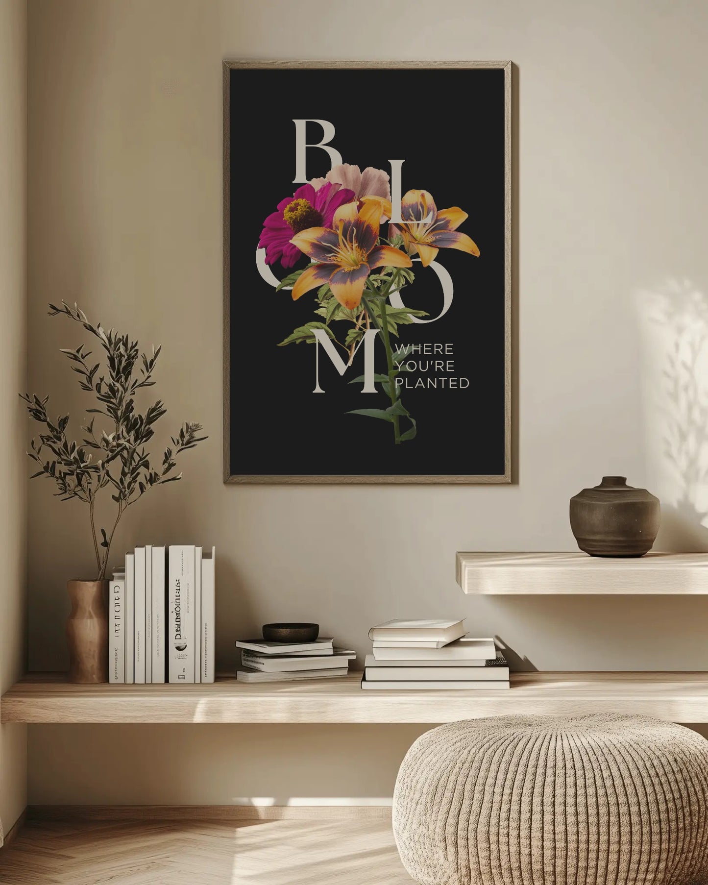 Framed floral artwork on a wall above a wooden shelf with books and decor items.