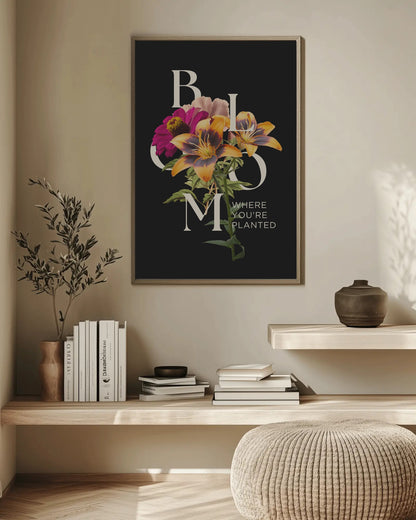 Framed floral artwork on a wall above a wooden shelf with books and decor items.