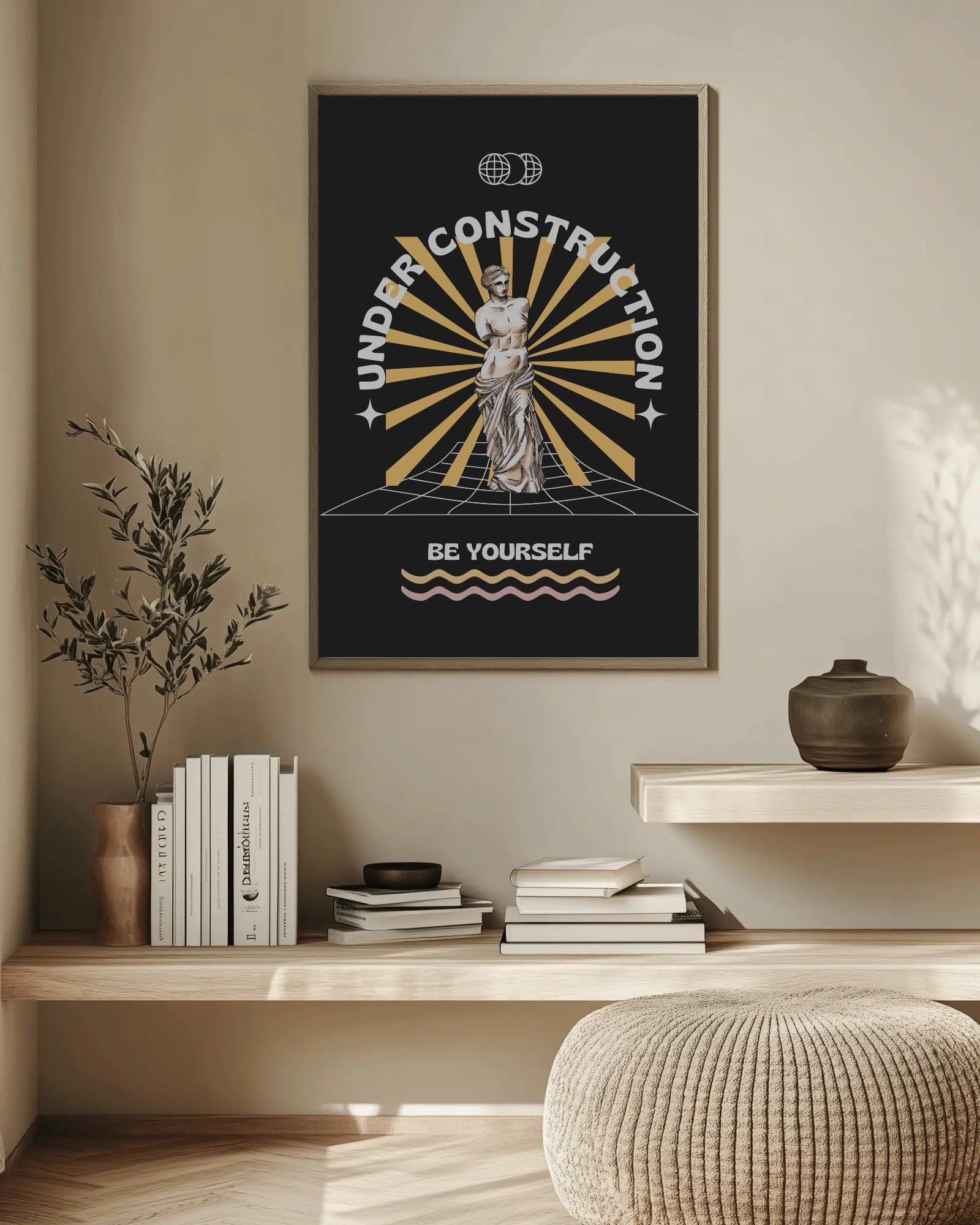 Framed poster with motivational quote on a wall above a wooden shelf with books and decor.