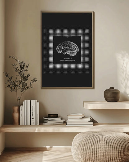 Framed brain artwork on a wall above a wooden shelf with books and decor.