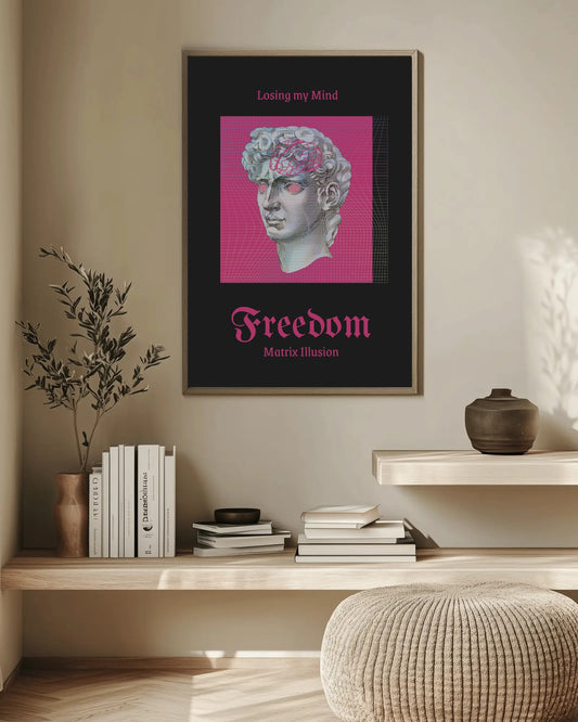 Framed artwork with a classical statue on a wall above a shelf with books and decor.
