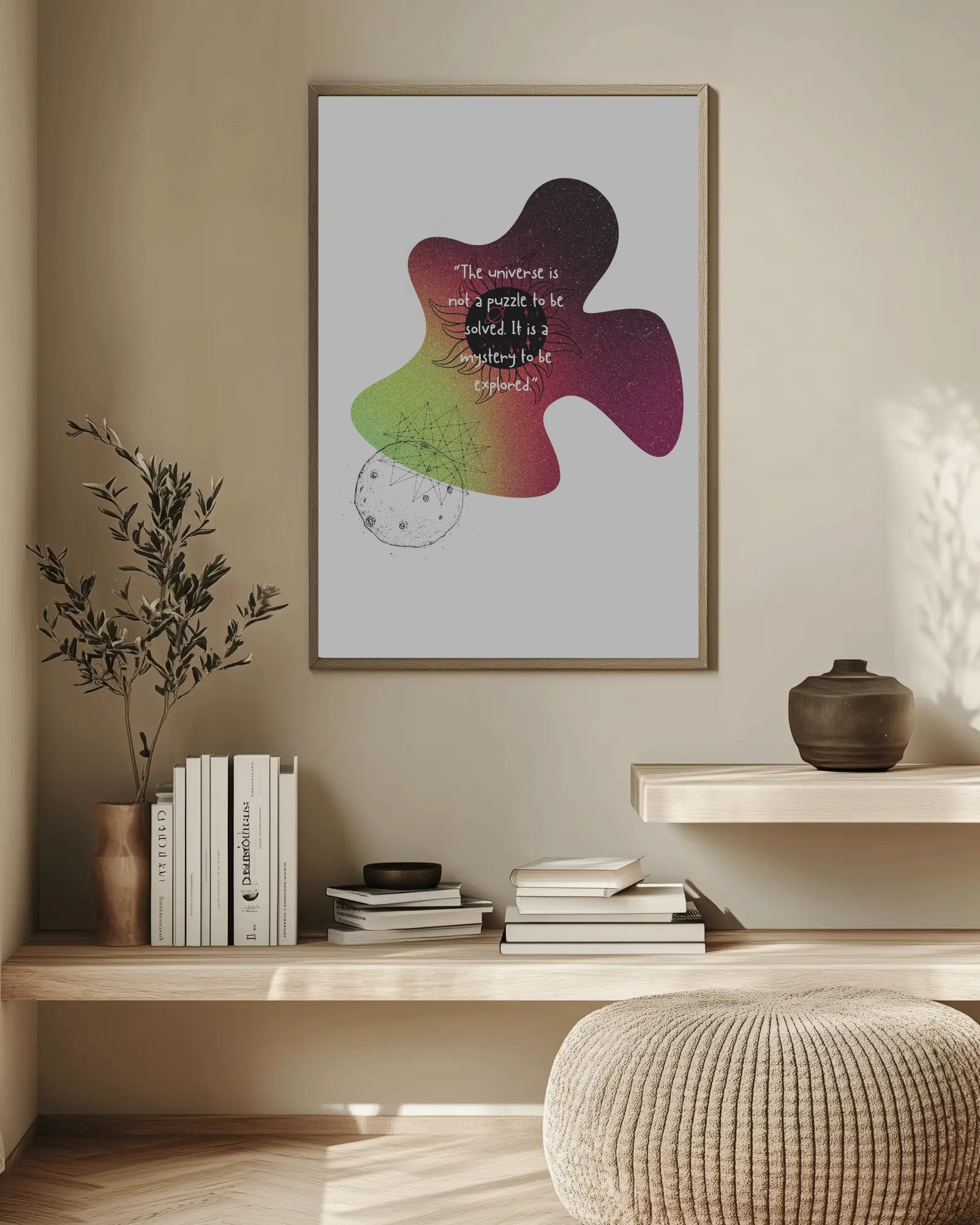 Framed abstract art piece on a wall above a wooden shelf with books and decor.